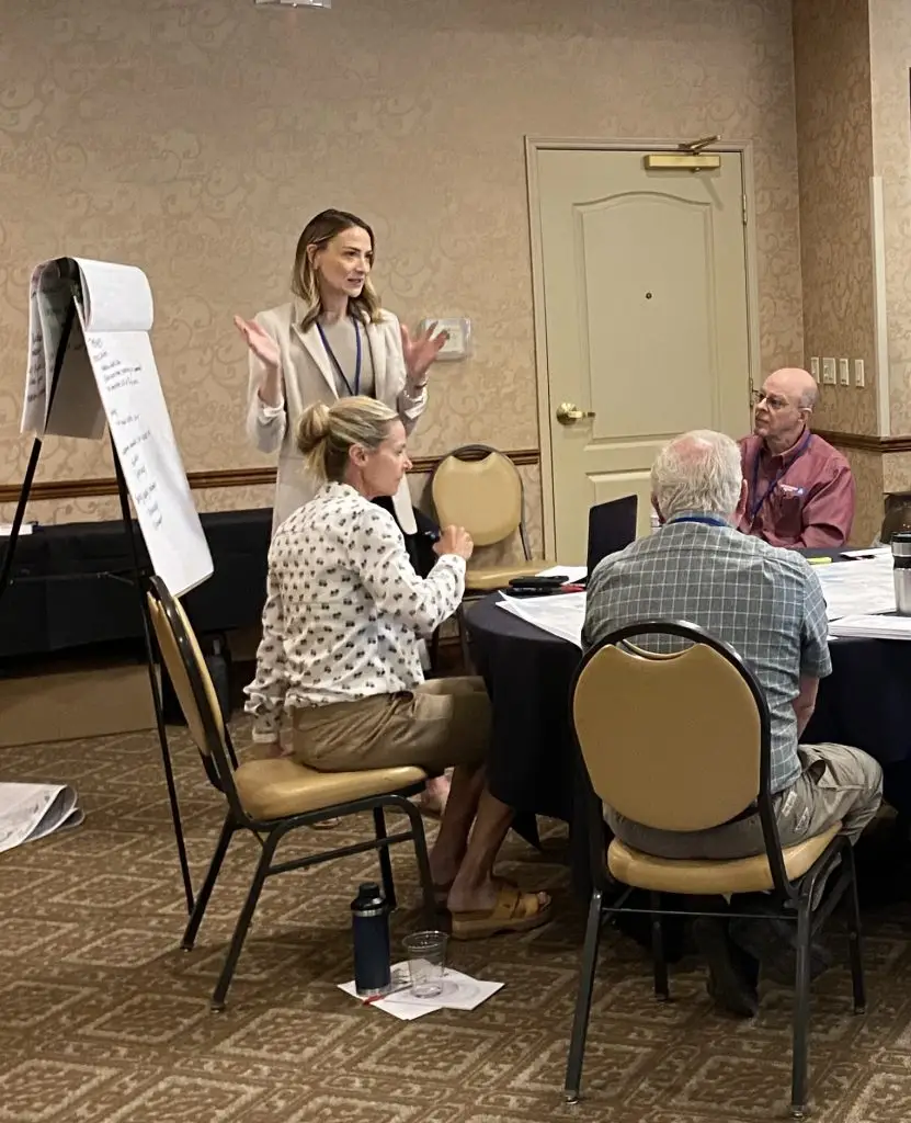 Woman standing at flipchart presenting at workshop