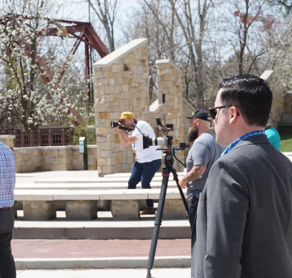 Man standing next to TV cameras