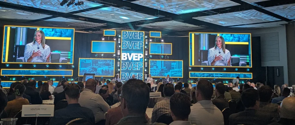 A panel at business conference on a large screen